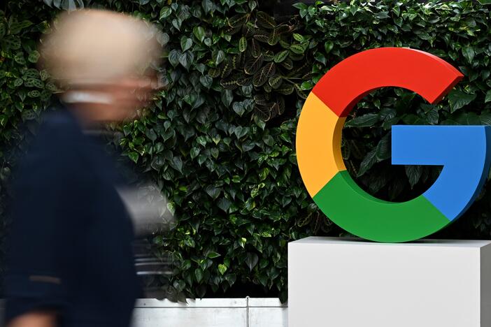 A woman walks past a Google logo at the Google Campus in Warsaw on Feb.13, 2025.