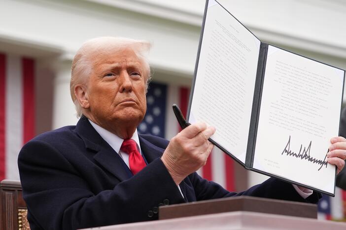 President Donald Trump displays a signed executive order imposing tariffs on imported goods during a "Make America Wealthy Again" trade announcement event in the Rose Garden at the White House on April 2, 2025 in Washington, D.C.