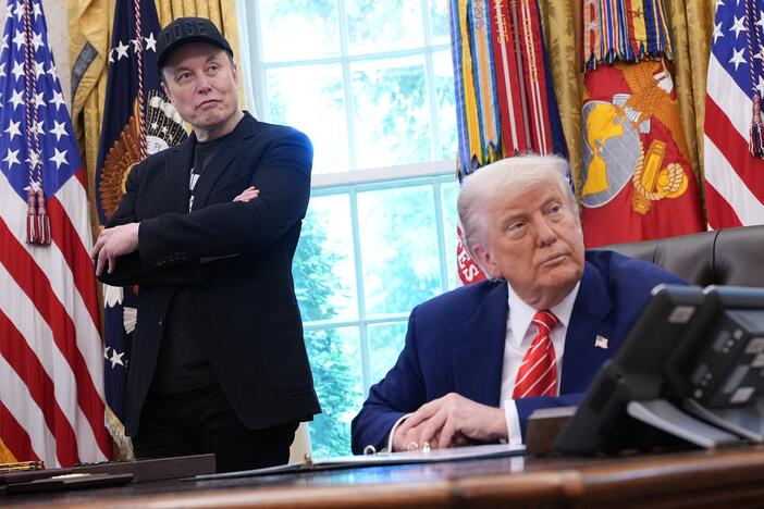 President Trump and his billionaire adviser Elon Musk listen to a question from a reporter in the Oval Office on Friday, as Musk concludes his role leading Trump's Department of Government Efficiency.