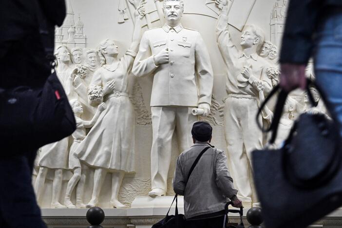 Commuters pause walking past the newly unveiled high relief depicting Soviet dictator Josef Stalin in a passage at Taganskaya metro station in Moscow on May 15, 2025.