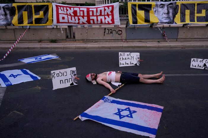 A demonstrator takes part in a performance during a protest demanding the end of the war and immediate release of hostages held by Hamas in the Gaza Strip, and against Prime Minister Benjamin Netanyahu's government in Tel Aviv, Saturday, May 31, 2025.