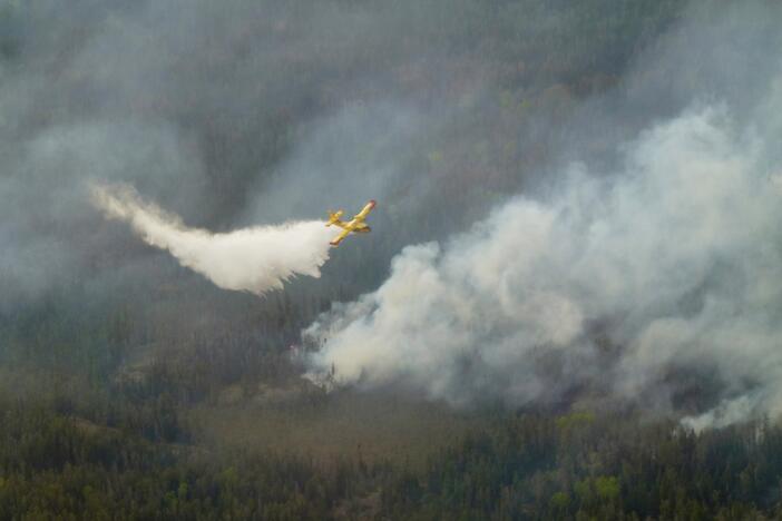 A water bomber aircraft battles a wildfire in southeast Manitoba as shown in this handout photo provided by the Manitoba government on Tuesday.