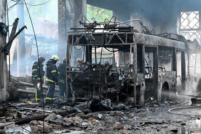 Ukrainian rescuers work to extinguish a fire in a trolleybus depot following a drone strike in Kharkiv on Friday, amid the Russian invasion of Ukraine.