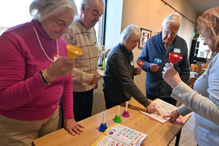 Paula Baille leads the group of Sharon Hannamaker, Joe Edwards, Barb Edwards, and Murray Small in a playing of the bells.