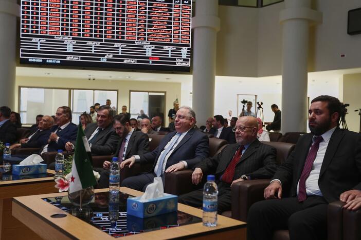 Syrian Finance Minister Mohammed Yisr Barnieh, center, attends the opening ceremony at the Damascus Securities Exchange in Damascus, Syria, Monday, June 2, 2025. (AP Photo/Omar Sanadiki)