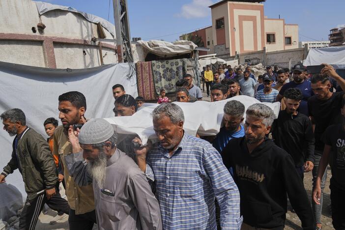 Palestinians carry the body of Reem Al-Akhras who was killed while heading to a Gaza aid hub, during her funeral in Khan Younis, southern Gaza Strip, Tuesday.