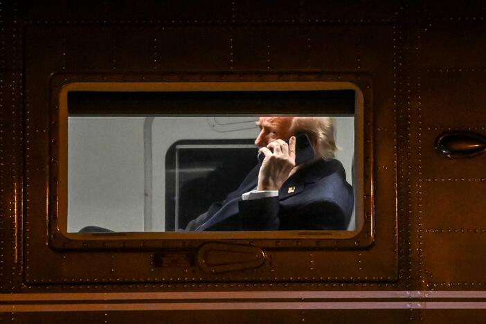 President Trump uses a cell phone aboard his Marine One helicopter in Leesburg, Va., on April 24, 2025.
