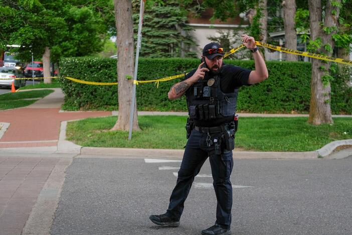 A police officer lifts police tape while exiting the scene of an attack on demonstrators calling for the release of Israeli hostages held in Gaza, on Pearl Street in Boulder, Colorado, on June 1.