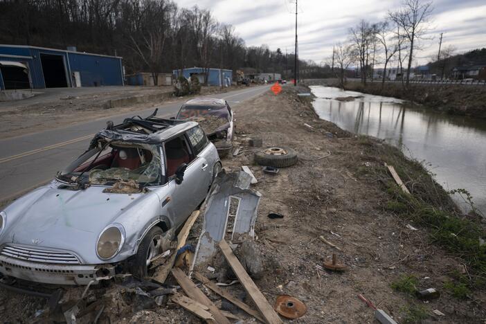 An abandoned vehicle sits along the Swannanoa River in a landscape scarred by Hurricane Helene, on March 24, near Swannanoa, N.C.