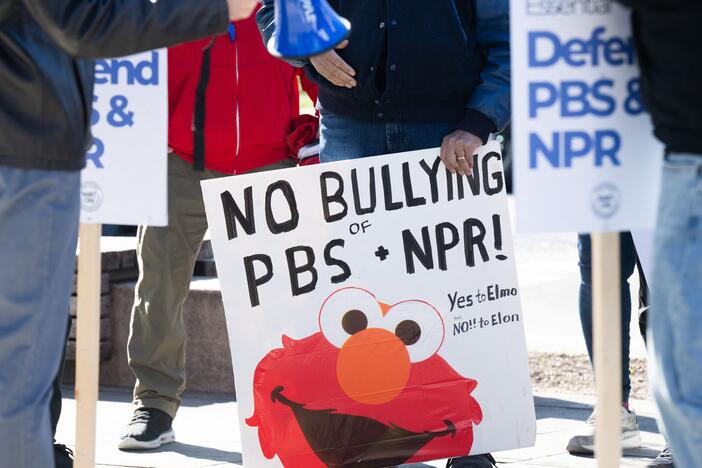 People participate in a rally to call on Congress to protect funding for public broadcasters PBS and NPR outside the NPR headquarters in Washington, DC, on March 26, 2025.