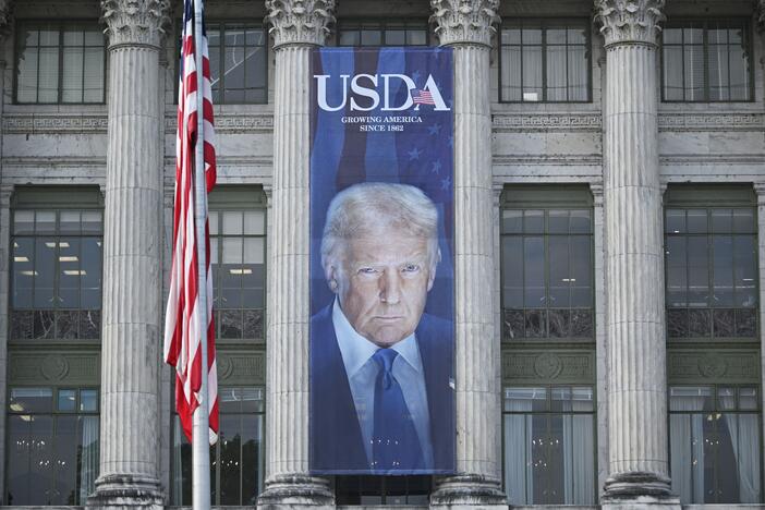 A banner showing an image of US President Donald Trump hangs on the side of a US Department of Agriculture building in Washington, DC, on May 16, 2025. USDA has put on hold a demand that states turn over sensitive data about food assistance recipients.