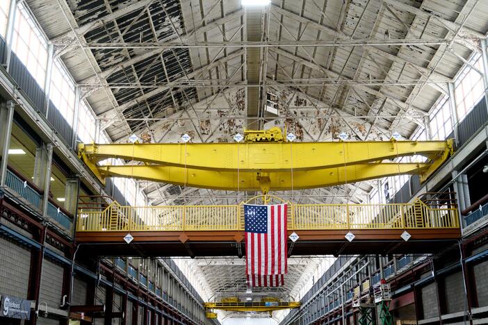 An American flag hangs inside the former Westinghouse plant in Turtle Creek, Pa., which now houses several businesses, including the Eos Energy Enterprises Inc. manufacturing facility.