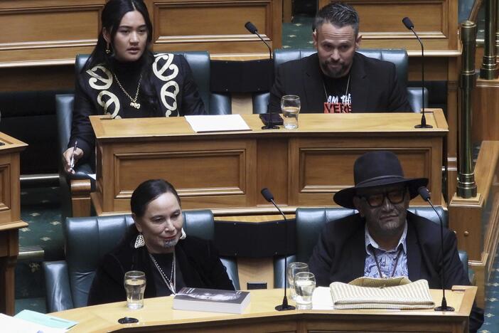 New Zealand lawmakers Hana-Rāwhiti Maipi-Clarke, top left, Debbie Ngarewa-Packer, bottom left, and Rawiri Waititi, bottom right, watch as other legislators debate their proposed bans in parliament in Wellington on Thursday, June 5, 2025.