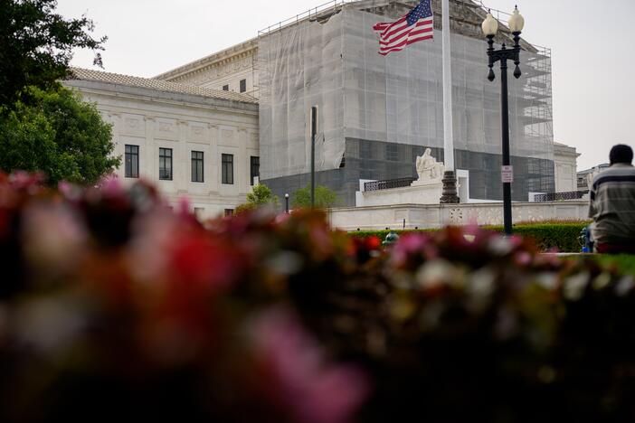 A person rests in front of the U.S. Supreme Court on June 5 in Washington, D.C.