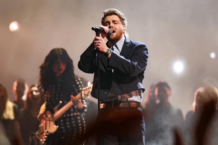 Alex Warren performs onstage at the 2025 American Music Awards.