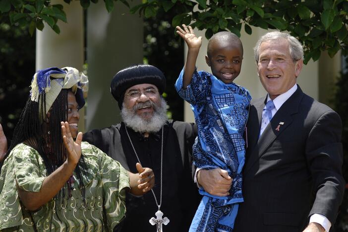 In this 2007 photograph, President George W. Bush holds Baron Mosima Loyiso Tantoh, 4, whose mother Kunene Tantoh, left, is HIV positive and who worked with a program for mothers with HIV in Cape Town that was supported by U.S. funds. At that time, Bush was asking Congress to approve $30 billion over the next five years for PEPFAR, the program that he'd established in 2003 to combat the spread of AIDS.