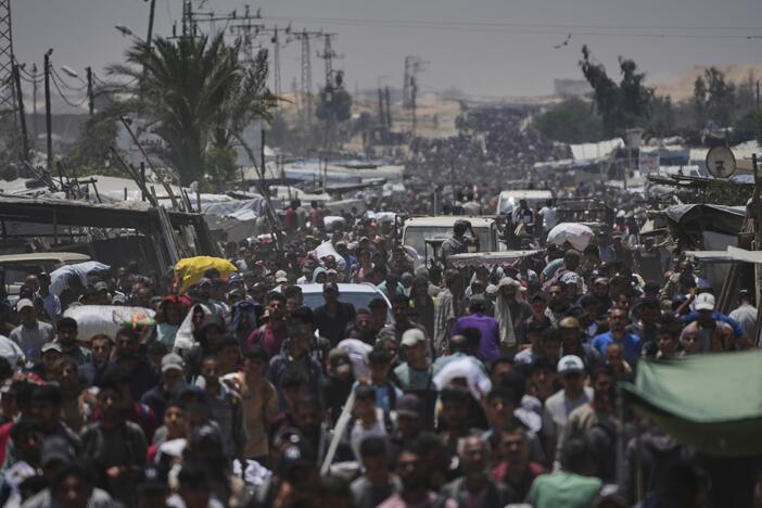 Palestinians carry bags containing food and humanitarian aid packages delivered by the Gaza Humanitarian Foundation, a U.S.-backed organization, in Rafah, southern Gaza Strip, Sunday, June 8, 2025.