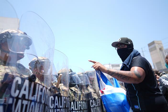 A protester confronts a line of U.S. National Guard in the metropolitan detention center of downtown Los Angeles on Sunday.