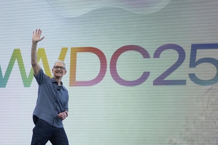 Apple CEO Tim Cook waves to attendees during an event on the Apple campus in Cupertino, Calif., Monday, June 9, 2025.
