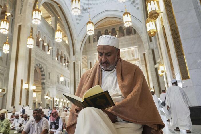 A Muslim pilgrim reads a copy of the Quran at the Grand Mosque during the annual Hajj pilgrimage in Mecca, Saudi Arabia.