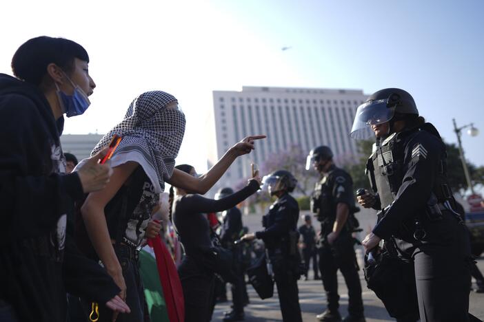 Protesters confront Los Angeles Police Department personnel in riot gear in downtown Los Angeles on Monday, June 9, 2025.