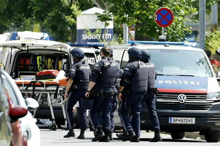 Police officers are seen in a street near a school where a gunman opened fire Tuesday morning in Graz, Austria.