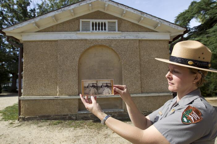 National Park Service Jennifer Mummart holds the photo of Selina Norris Gray, at the site where was taken at Arlington National Cemetery Oct. 9, 2014, in Arlington, Va. Gray was a black woman known for saving some of George Washington's heirlooms when Union soldiers seized and occupied Arlington House, the home of Confederate Army General Robert E. Lee, on May 24, 1861.