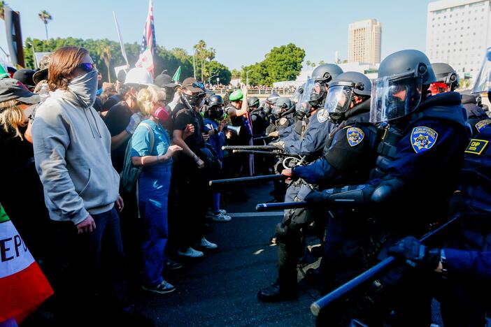 California Highway Patrol officers attempt to control crowds on the 101 Freeway during an anti-ICE protest in downtown Los Angeles on Sunday. Protests erupted after a wave of federal immigration raids began around the city, with National Guard troops deployed despite objections from local officials.