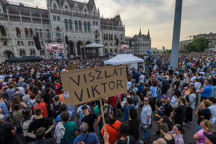 Demonstrator hokds a placard reading "See you (never) Viktor" when thousands gather in front of the Parliament in central Budapest, Hungary, on June 10.