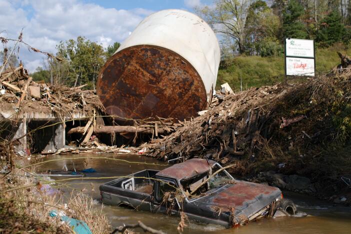 A truck is stuck in water and mud following flooding from Hurricane Helene in western North Carolina.