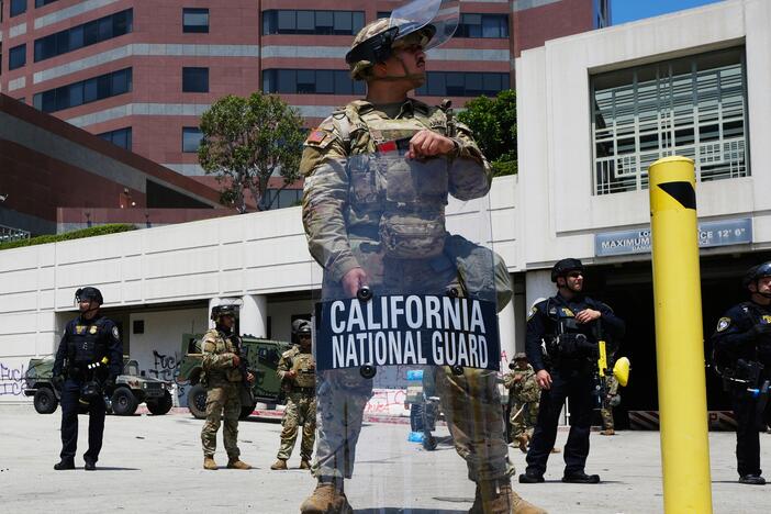 U.S. National Guard stand protect buildings Tuesday in Los Angeles.