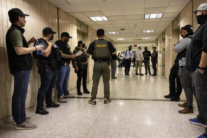 Federal agents wait outside an immigration courtroom at the Jacob K. Javits Federal Building in New York on June 10, 2025.
