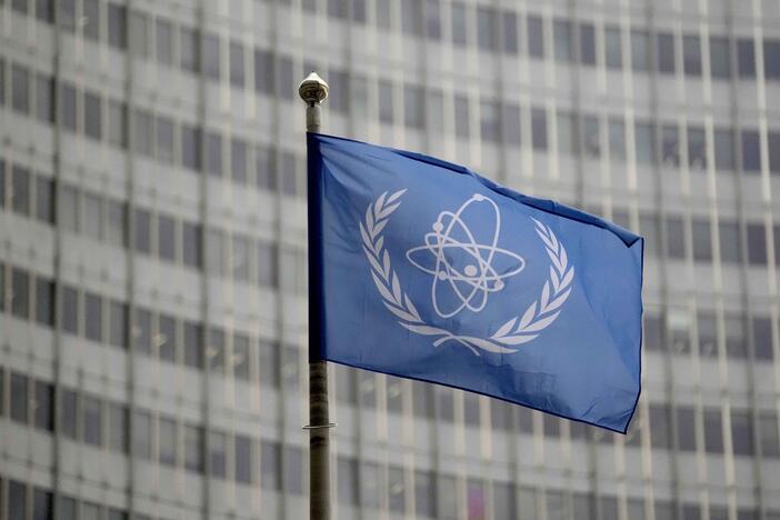 The flag of the International Atomic Energy Agency flies in front of its headquarters during an IAEA Board of Governors meeting in Vienna, Austria.