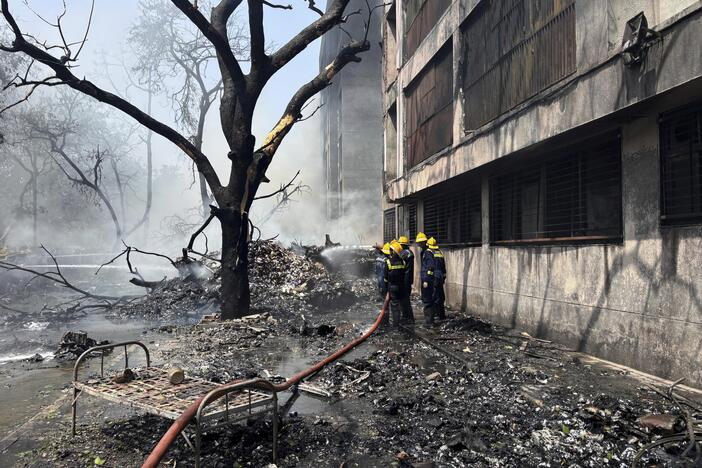 Firefighters work at the site of an airplane that crashed in India's northwestern city of Ahmedabad in Gujarat state on Thursday.