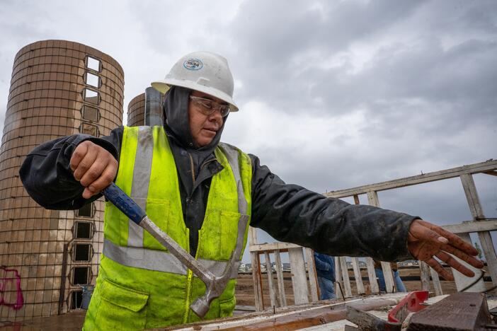 On the site of a former ranch slated for housing development in the suburbs of Aurora, Colorado, Padreo Macedo of Perks Deconstruction, pull nails from a wood frame that once stood in a barn. May 5, 2025.