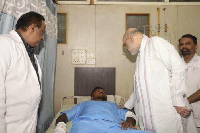 Viswashkumar Ramesh, the sole survivor of Thursday's Air India crash, meets with Home Affairs Minister Amit Shah at a hospital in Ahmedabad.