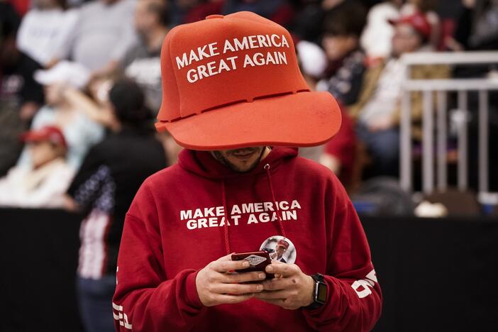 A supporter of President Trump wears an oversize "Make America Great Again Hat" at a rally at Southern New Hampshire University Arena on Feb. 10, 2020, in Manchester, N.H. Trump narrowly won young men last fall, a 12-point shift from four years earlier when Biden won the group by 11 percentage points.