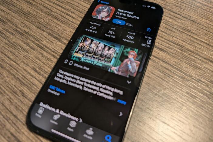 A phone displaying the App Store page for the mobile game Reversed Front: Bonfire.