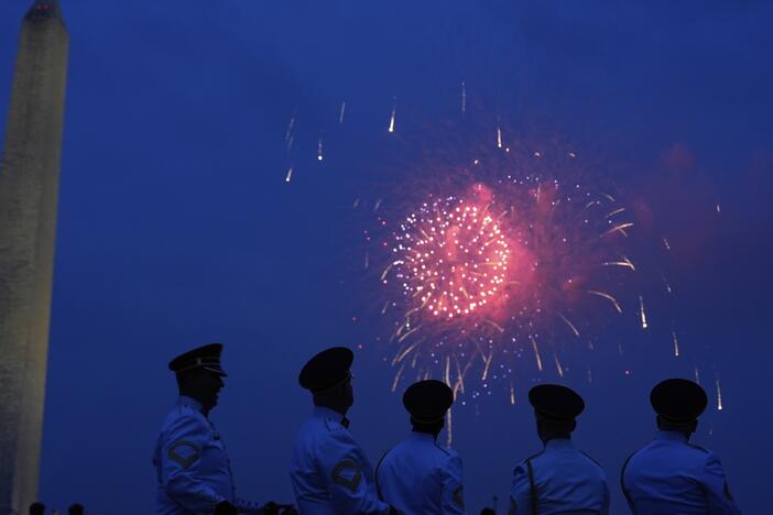 Members of the U.S. Army Band "Pershing's Own" watch fireworks at the end of a military parade commemorating the Army's 250th anniversary on Saturday in Washington, D.C.