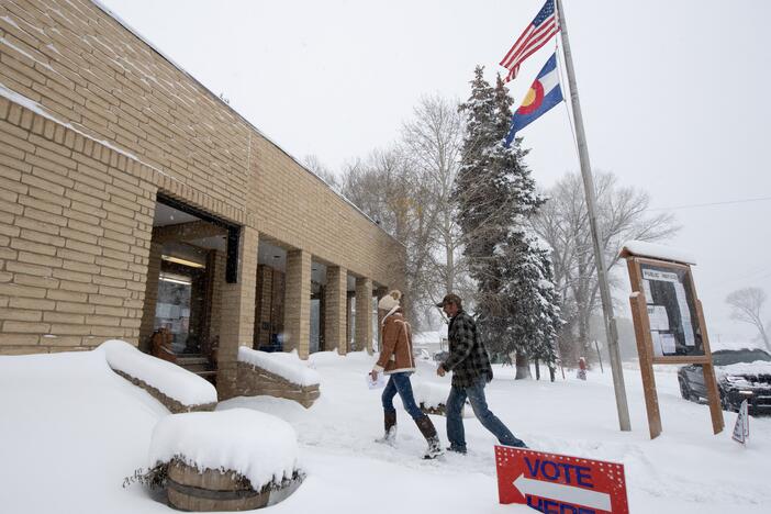 Voters walk into the Oak Creek Town Hall to drop off their ballots on Nov. 5, 2024, in Oak Creek, Colo.