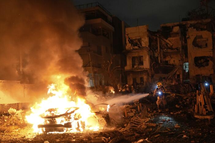 Firefighters work to extinguish a blaze after a missile launched from Iran struck Tel Aviv, Israel, on Monday.