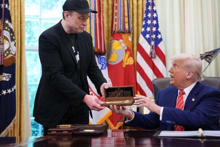 Elon Musk receives a key from President Trump in the Oval Office on May 30, 2025 to thank him for his work with the Department of Government Efficiency. Days later, the pair were feuding online, though Musk has since apologized.