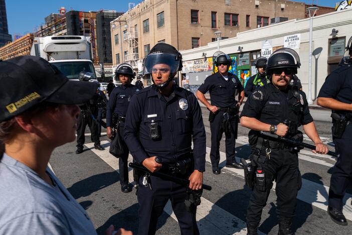 Police monitor participants in an anti-ICE rally in downtown Los Angeles last week. Press advocates say law enforcement officials have violated journalists' rights as they cover the rallies. Some journalists say they believe they have been targeted by police officers seeking to intimidate them from reporting on what is happening there.