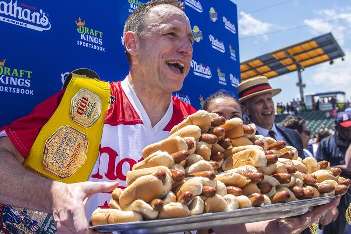 Sixteen-time champion Joey Chestnut poses after his 2021 Nathan's Famous Fourth of July International Hot Dog-Eating Contest victory on Coney Island. He returns to the stage this summer after being banned last year.