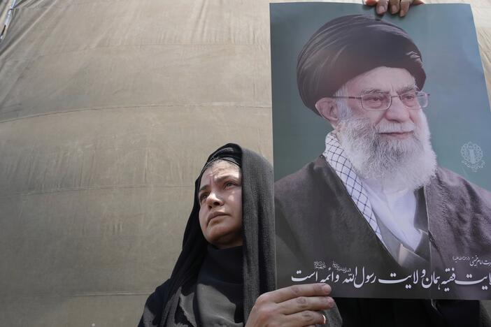 An Iranian protester holds up a poster of the Supreme Leader Ayatollah Ali Khamenei in an anti-Israeli gathering in Tehran, Iran, Friday, June 13, 2025.