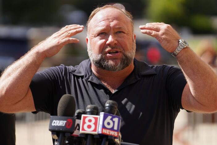 InfoWars founder Alex Jones speaks to the media outside Waterbury Superior Court during his trial on September 21, 2022 in Waterbury, Connecticut in which he was being sued by several victims' families for causing emotional and psychological harm after they lost their children in the Sandy Hook massacre.