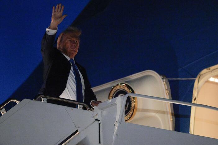 U.S. President Donald Trump waves as he boards Air Force One after leaving the G7 Leaders' Summit early on June 16, 2025 in Calgary, Alberta.