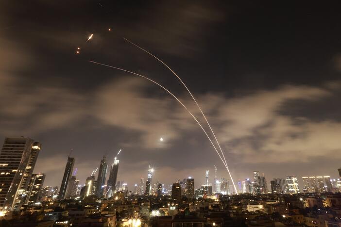 Israeli air defense systems fire to intercept Iranian missiles over Tel Aviv before dawn Wednesday. Israel and Iran exchanged fire for a sixth day.