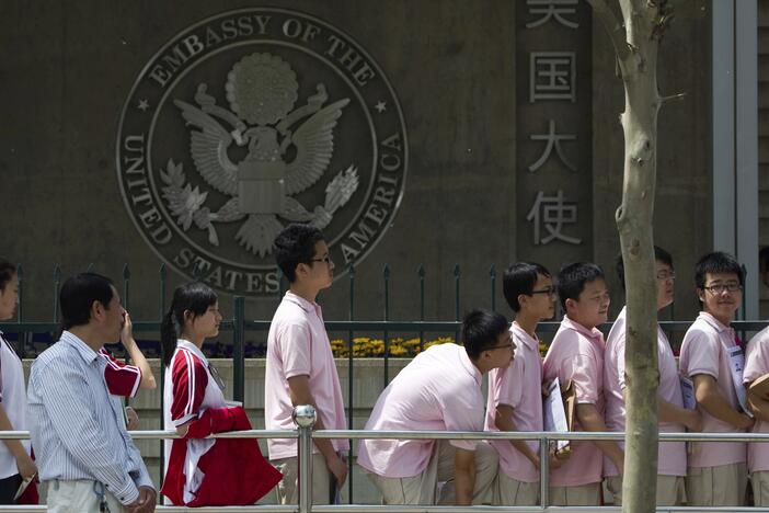 Chinese students wait outside the U.S. Embassy for their visa application interviews, in Beijing on May 2, 2012.