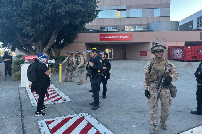 Anti-ICE protesters face off with Homeland Security officers and Marines outside the federal building in downtown Los Angeles on Monday evening